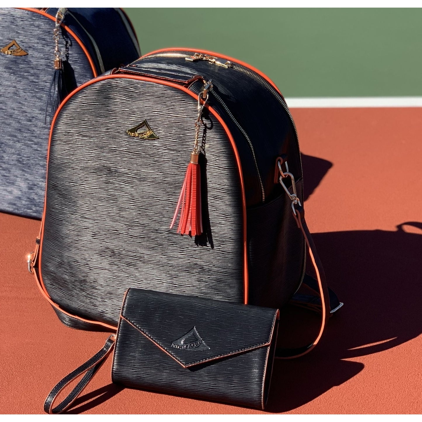 HANA water ripple pattern bag for tennis racquets;  paddles and travel;  free clutch and tassel;  gold hardware and full features for all sports.